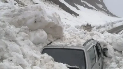 Trabzon’un Hayrat ilçesinde seyir halindeki bir otomobilin üzerine tonlarca kar